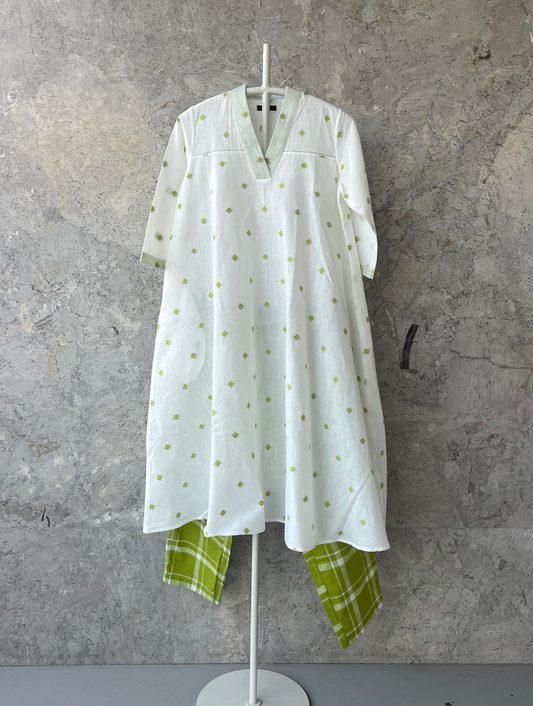 White cotton umbrella-cut kurta with green butti and thread-detailed V-neckline by Indian designer Sonal Kabra – Sunlit Stories summer collection.