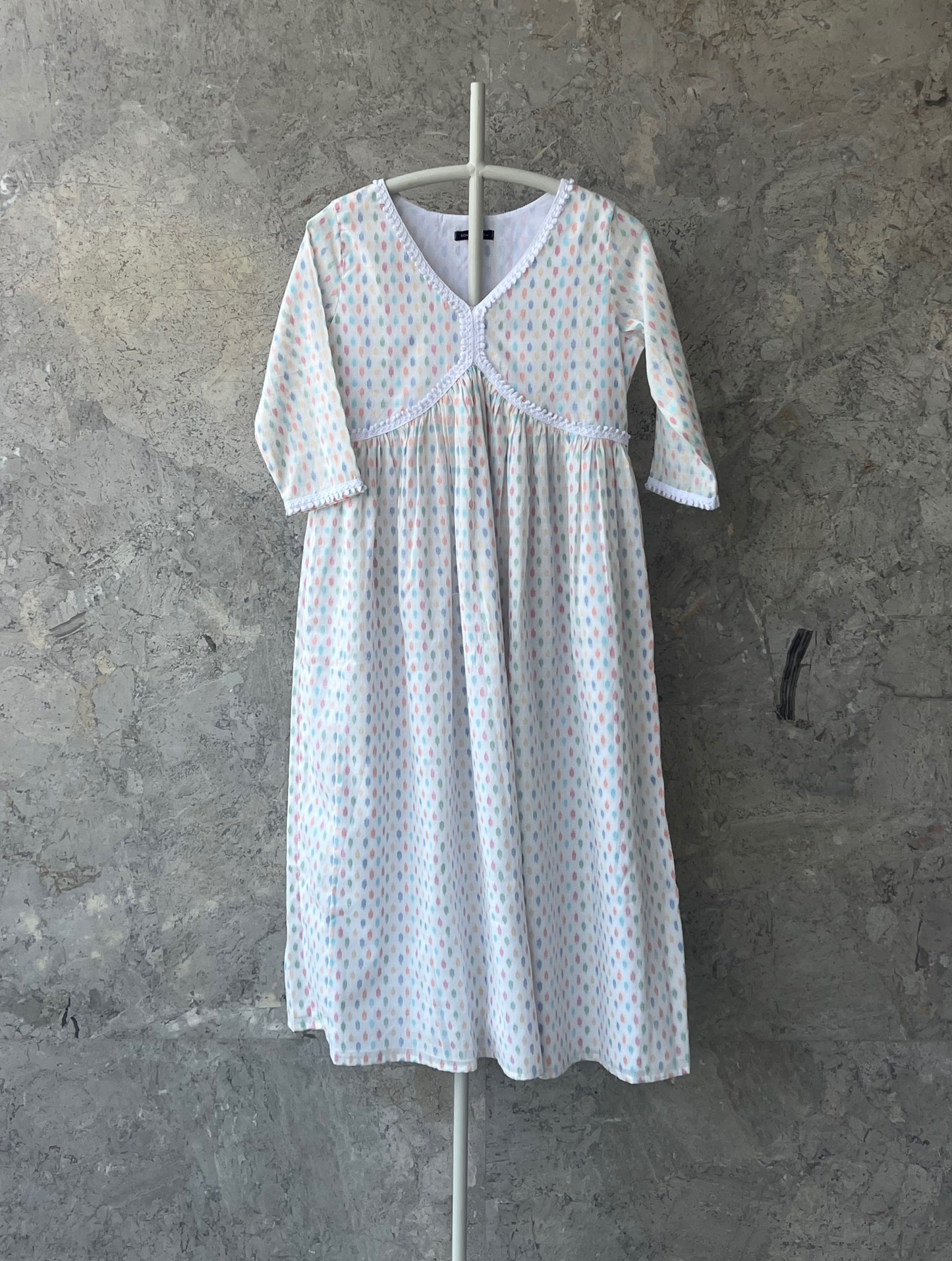 White cotton kurta with multicolor butti and lace detail, breathable summer wear by Indian designer Sonal Kabra from the Sunlit Stories collection.