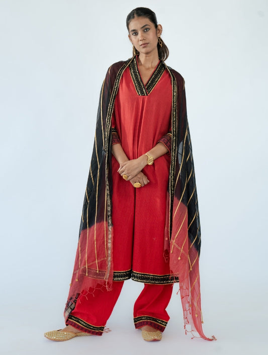 Black Kota Doria Dupatta with coral red dip-dye, black thread and sequin lace, golden gota stripes, and a cotton zari backing – a handcrafted Indian designer piece.