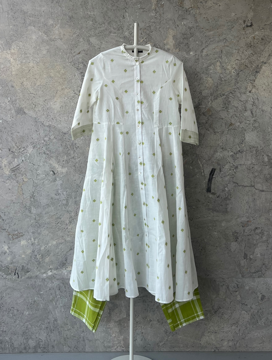 White cotton jacket dress with green butti, ruffle neckline, side kalis, and 3/4th sleeves by Indian designer Sonal Kabra – Sunlit Stories summer collection.