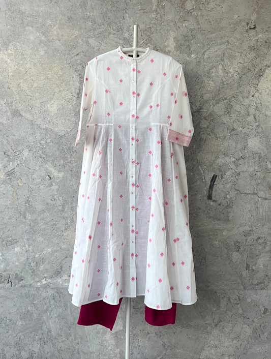 White cotton jacket dress with pink butti, princess cut, side kalis, and ruffle neckline – Indian designer Sonal Kabra summer kurta.