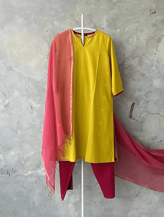 Yellow cotton kurta by Indian designer Sonal Kabra with pink border and piping, breathable summer wear from Sunlit Stories collection.