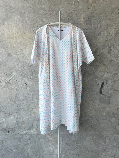 White cotton kaftan with multicolor butti, V-neck and belt, lightweight summer wear by Indian designer Sonal Kabra from the Sunlit Stories collection.
