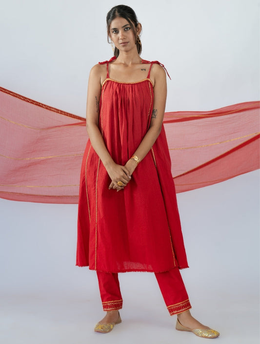 Kumkum Red A-line Kurta Set with Cigarette Pants by Sonal Kabra, crafted in breathable cotton with golden zari detailing, golden lace neckline, and red thread lace hem.