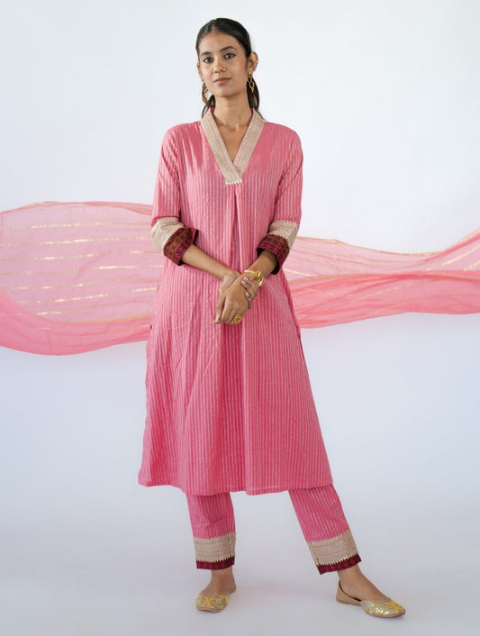 Pink A-line kurta set with golden lace, sequins, and cigarette pants