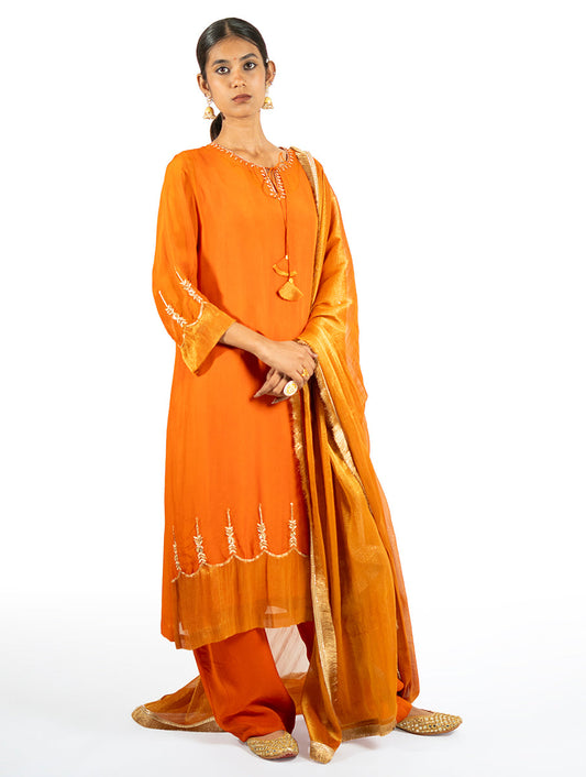 Orange organza kurta set with kasab, zardosi embroidery, tissue appliqué hems, and a matching dupatta by Indian designer Sonal Kabra.