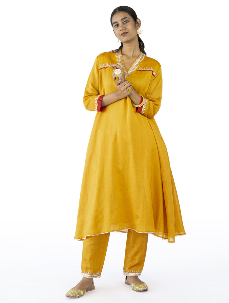 Mustard Chanderi flared kurta set with zardosi embroidery, side pockets, and embroidered pants – handcrafted Indian designer wear by Sonal Kabra.