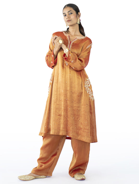 Red tissue A-line kurta set with zardosi, tikki, and tari embroidery, featuring side pockets and matching fully lined palazzo pants – handcrafted Indian designer wear by Sonal Kabra.