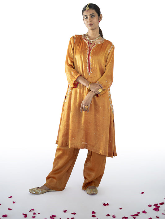 Orange tissue A-line kurta set with zardosi, tikki, and tari embroidery, fully lined with side pockets, paired with matching palazzo pants – handcrafted Indian designer wear by Sonal Kabra.
