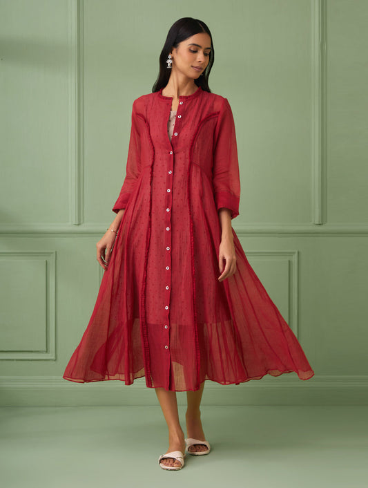 This red jacket dress is ideal for parties and housewarmings, a calf-length design with sophistication. This Indo western dress makes for a perfect gift for your loved ones. It comes with a comfortable slip dress that is hand block printed with polka dots. The dress is beautifully adorned with intricate hand stitches and delicate ruffles.