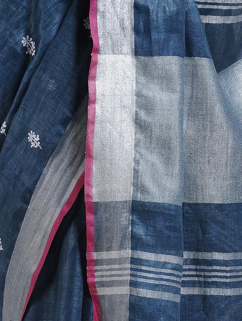 Organic blue fabric overlapping silver strips, small butties of white thread, elegant look 